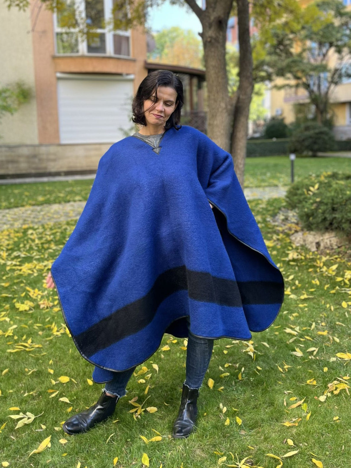 Woman wearing a blue blanket poncho also mexican poncho.