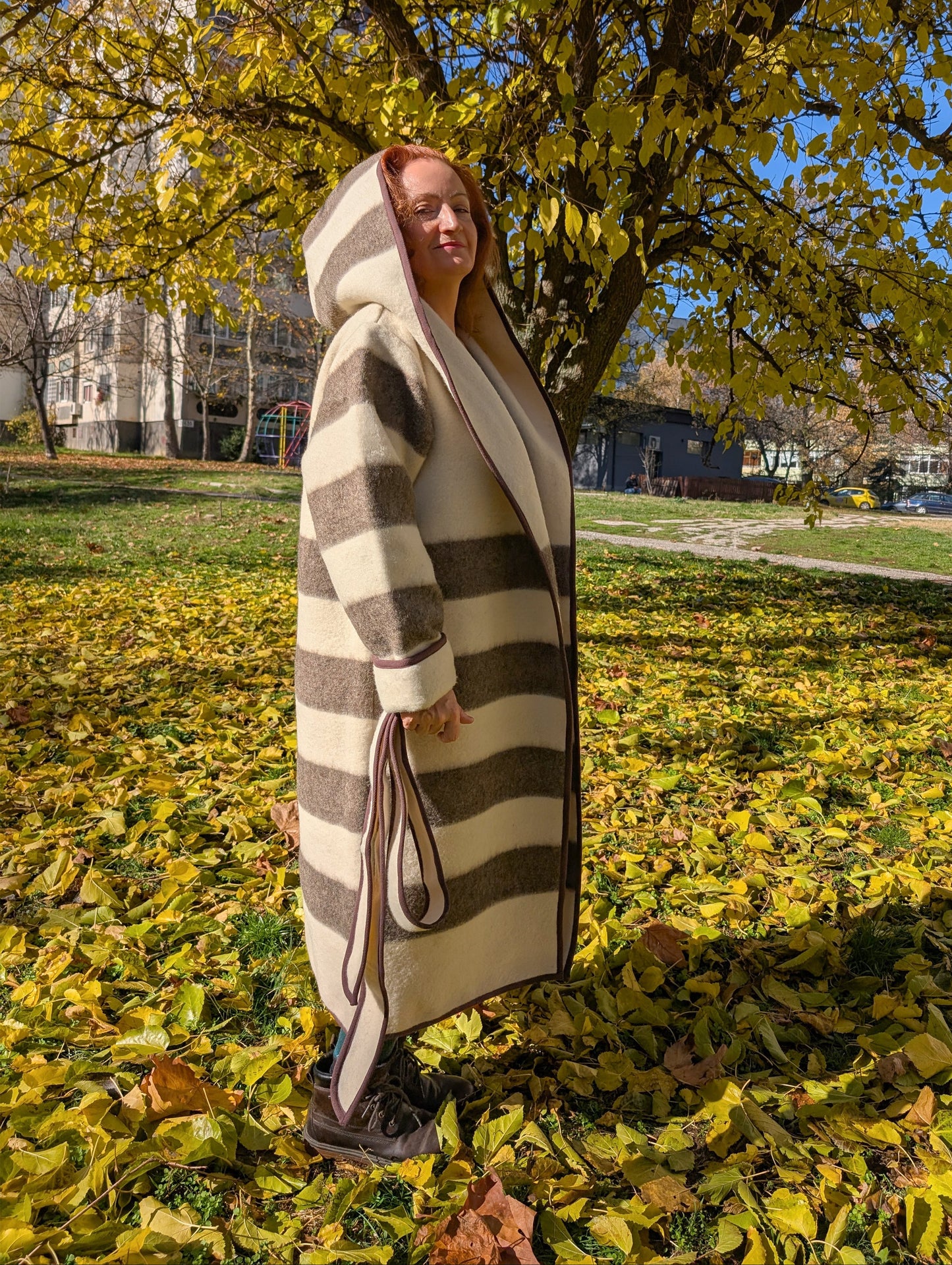 Long striped indigenous jacket with a wide shawl hood and an optional belt, all upcycled from a sustainable eco pure wool blanket