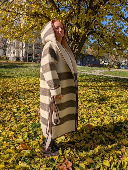 Long striped indigenous jacket with a wide shawl hood and an optional belt, all upcycled from a sustainable eco pure wool blanket