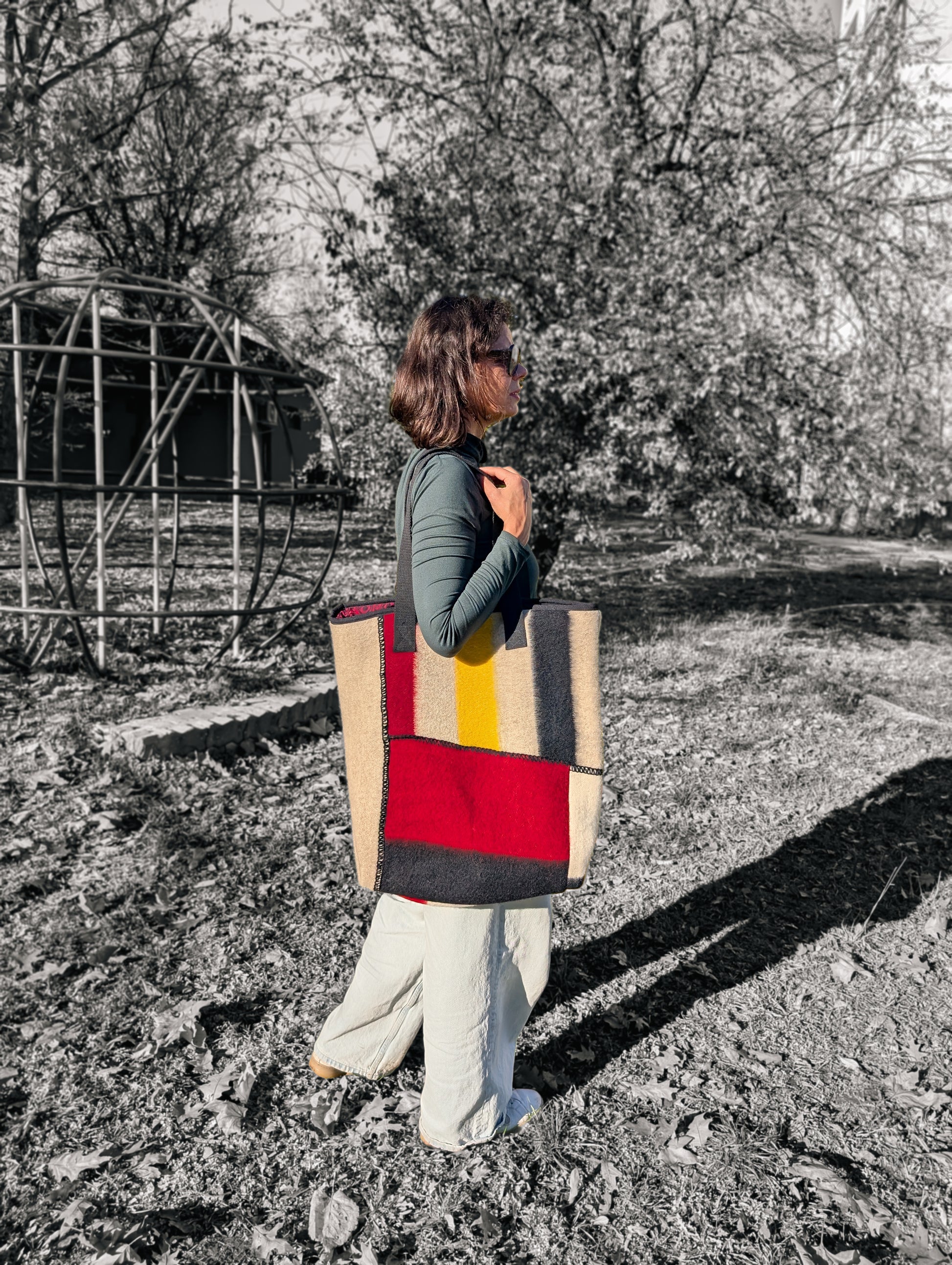 Woman looking fashionable with an upcycled patchwork geomatric pattern wool tote bag.