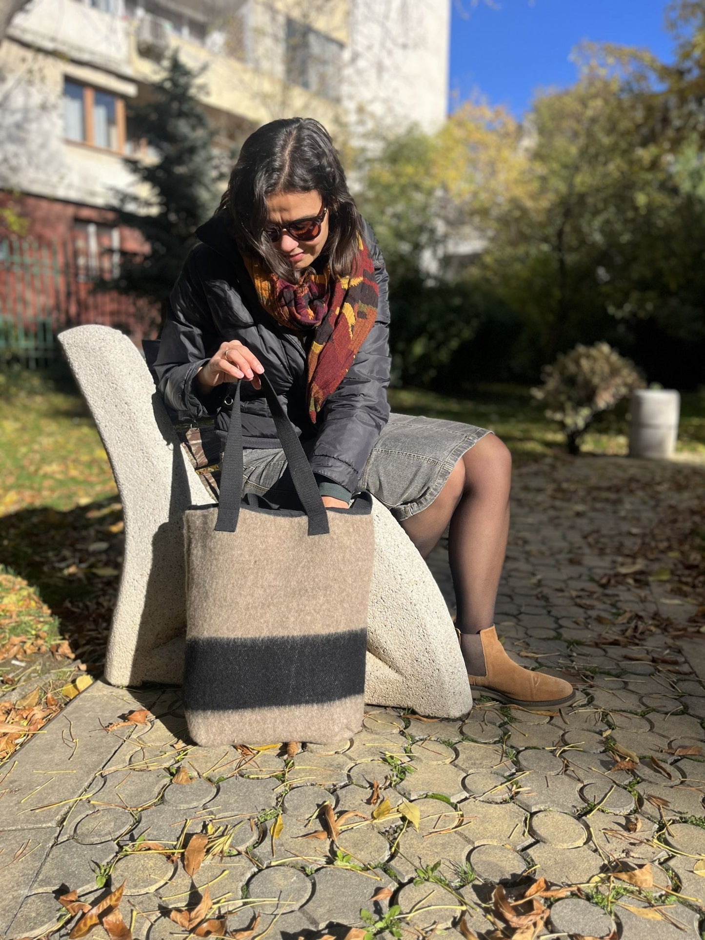 Woman showing her stylish modern handmade bag as a slow fashion statement.