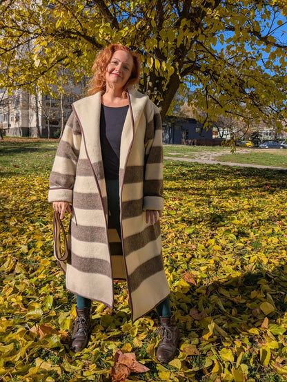 Long loose undyed wool stripe jacket, in beige with natural brown stripes, worn open like a robe coat.