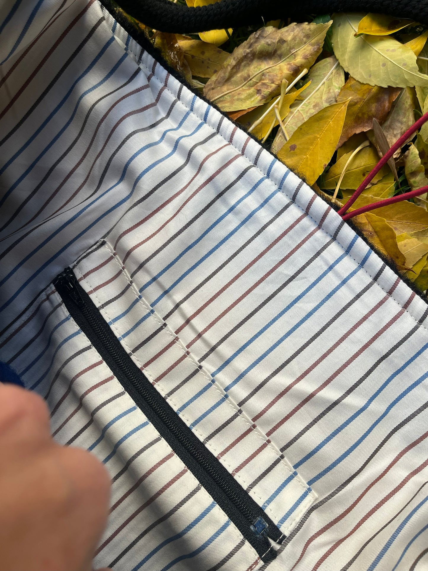 Close-up of a tote bag interior cotton lining with a zipper pocket.