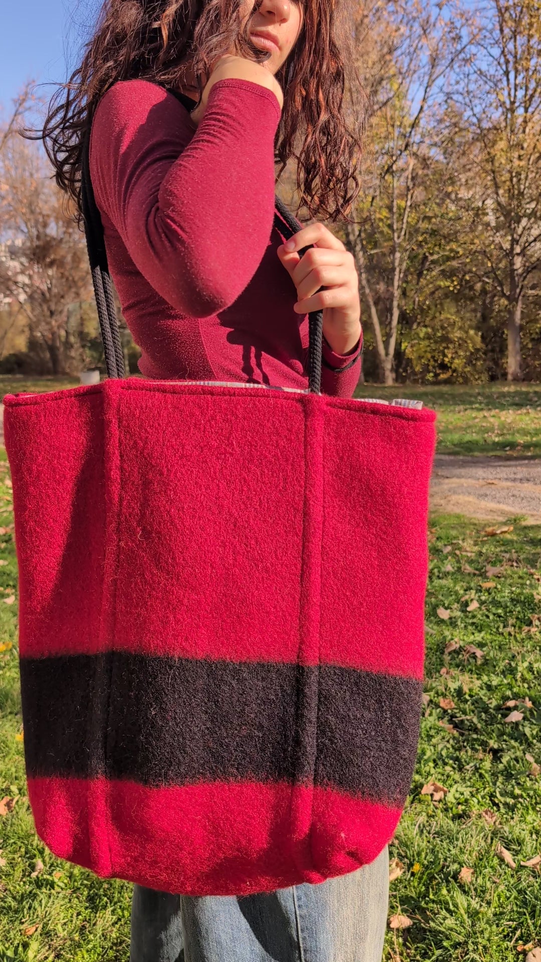A modern statement slow fashion unisex  bag for all ages in deep red with a solid black stripe. 