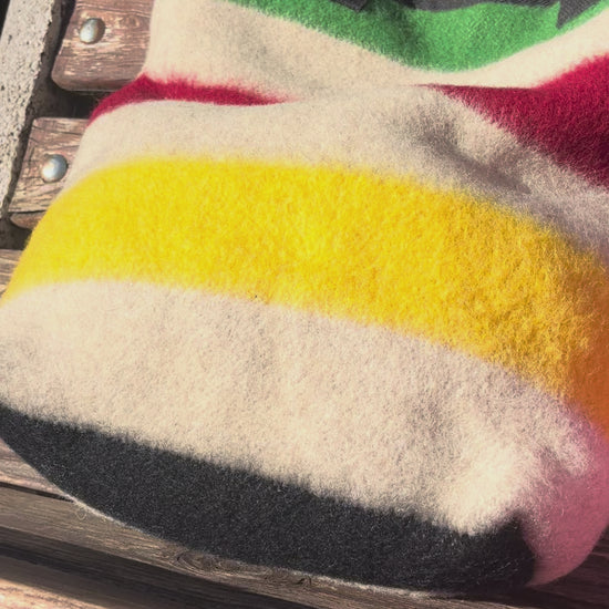 video showing a modern everyday tote bag made from luxurious traditional stripe blanket associated with old traditions and first nations' fur trade times.
