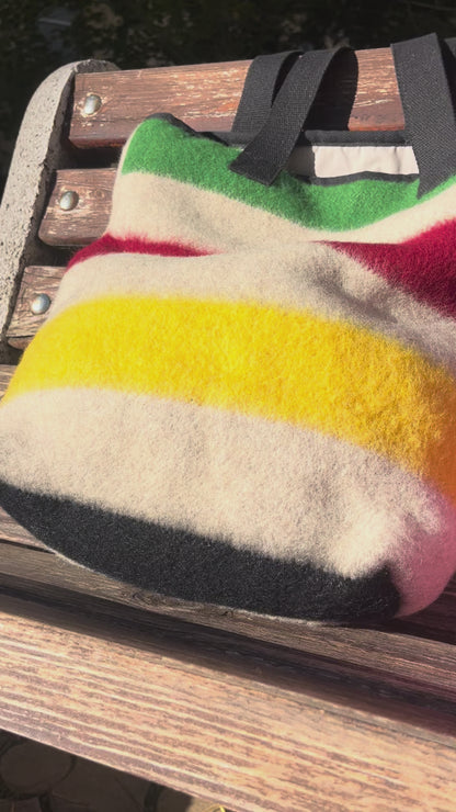 video showing a modern everyday tote bag made from luxurious traditional stripe blanket associated with old traditions and first nations' fur trade times.