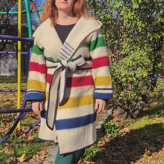 A video of ivory midi wrap coat tailored from artisan sustainable sheep wool blankets