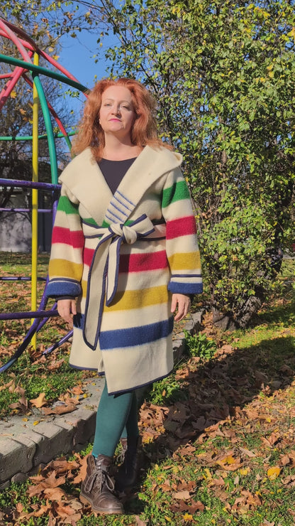 A video of ivory midi wrap coat tailored from artisan sustainable sheep wool blankets