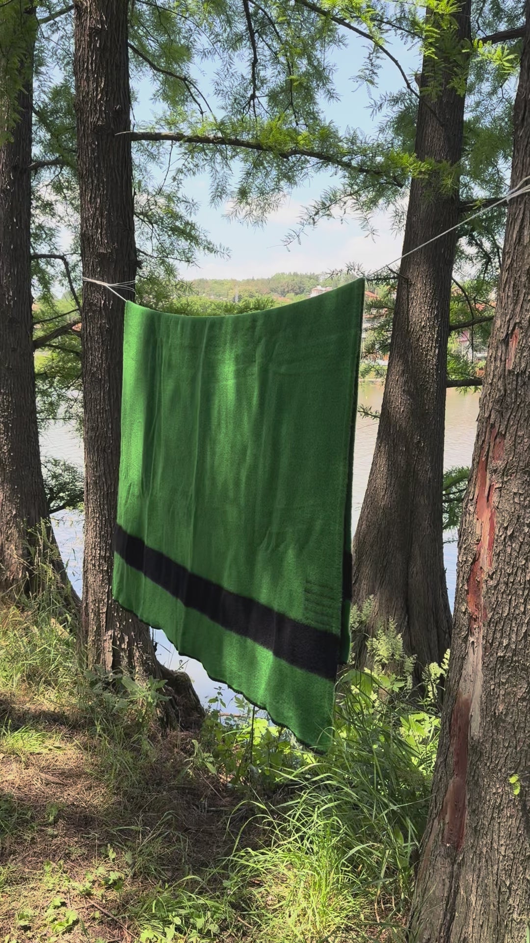 video of a classic traditional heirloom blanket. Green canadiana blanket with black stripes. 